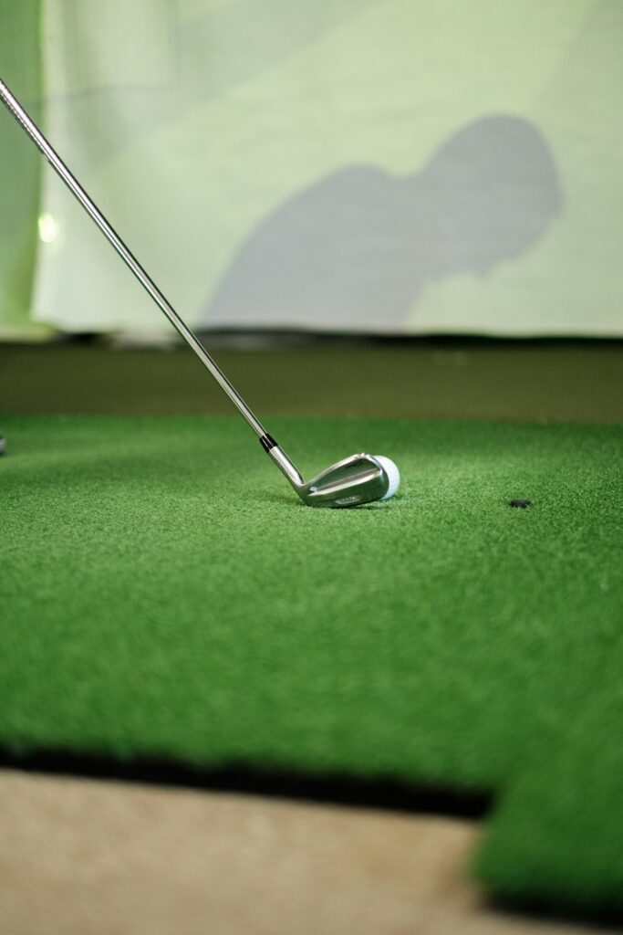 A mid-handicap golfer focusing on a putting practice session on a green with crisp evening light.